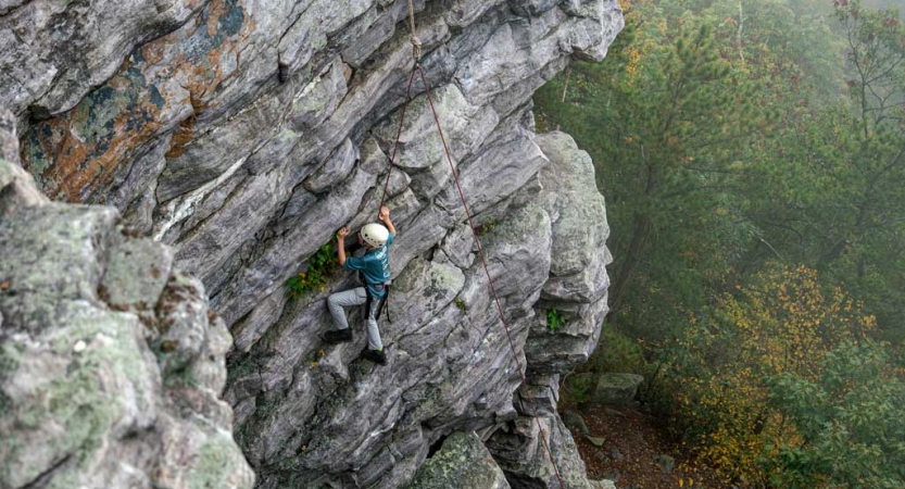 a student climbs a rock wall near DC on a trip with Outward Bound